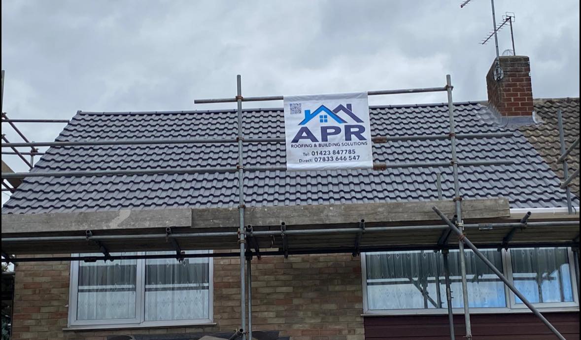 Complete Roof Replacement - Harrogate - Full roof replacement with new concrete tiles and APR branding on site.