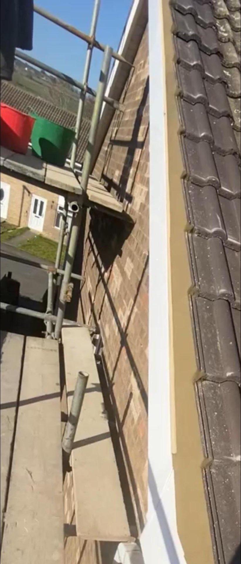 Fascia Installation with Tiles - York - New fascia boards installed alongside tile roofing work.