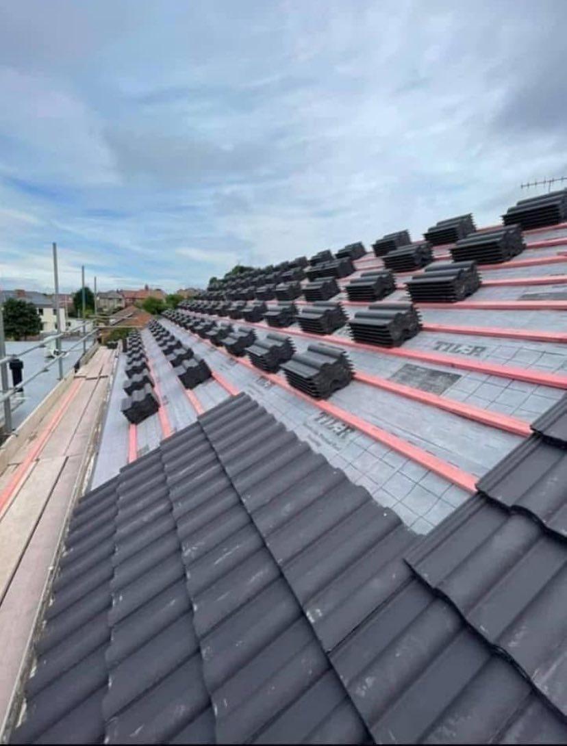 Stacks of new concrete roof tiles ready for professional roof installation in Yorkshire