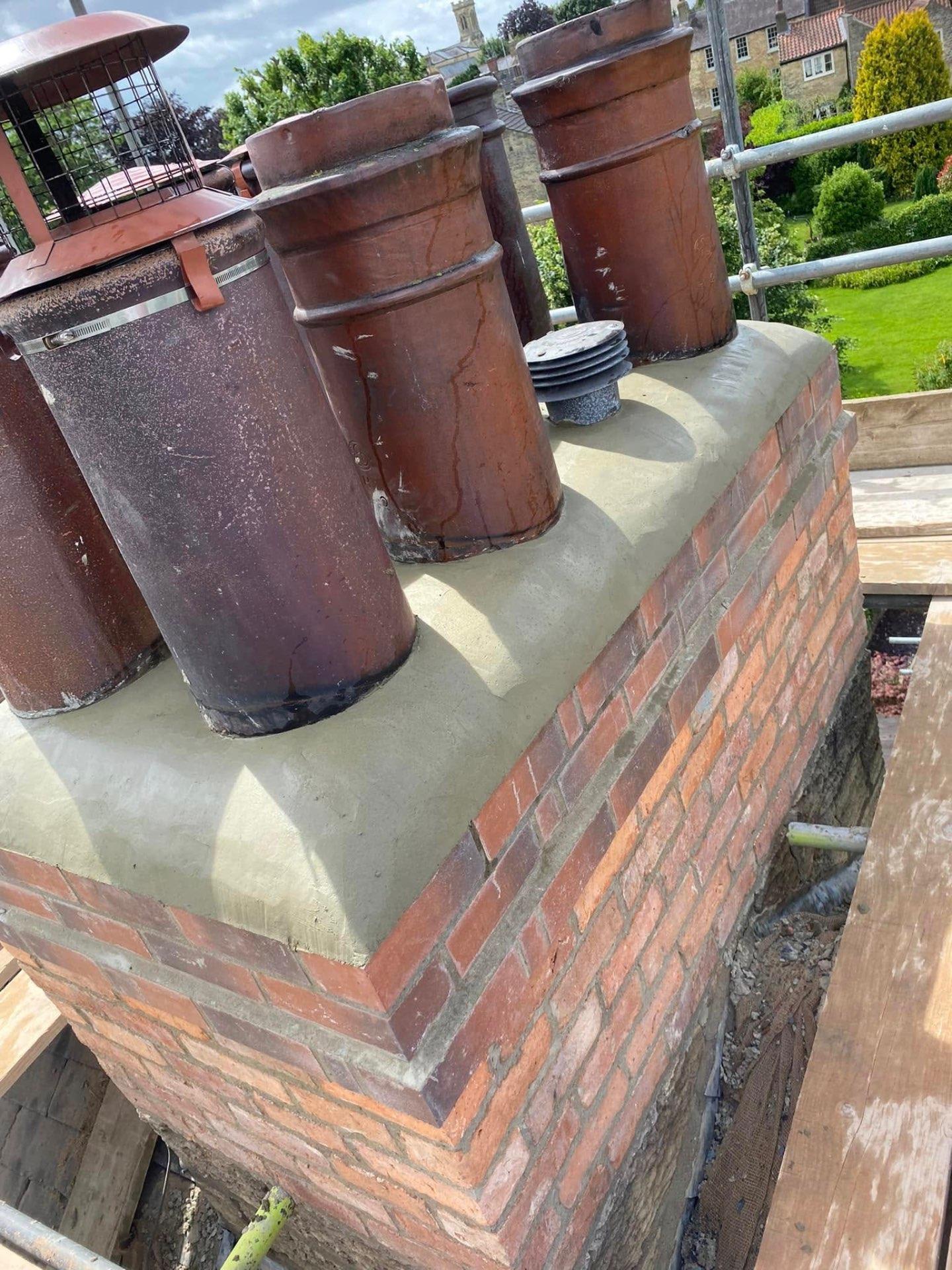Newly rebuilt chimney stack with fresh mortar and lead flashing