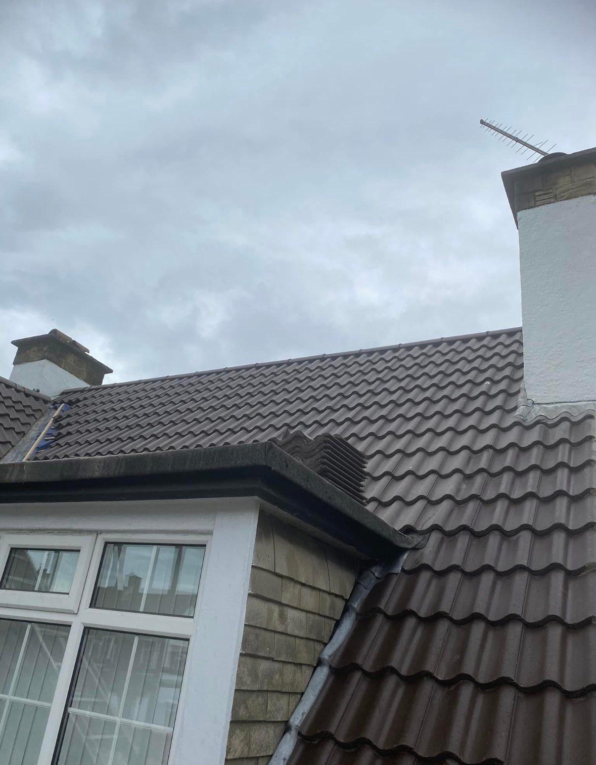Completed new roof installation on a Yorkshire property showing new tiles and ridge work