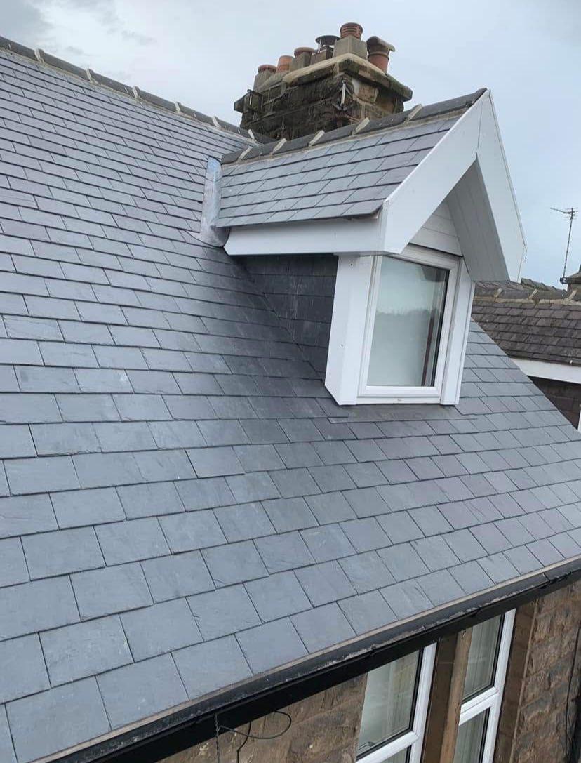 Completed slate dormer loft conversion with new window and lead valley flashing